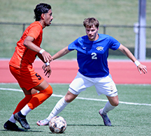 Barton men's soccer 's Nils Knecht guards Cowley's Adriano Melo